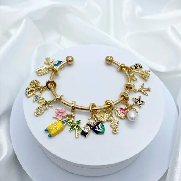 Linx Yellow Gold Open Bangle with Travel Themed Charms